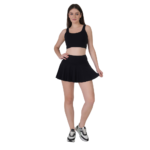 Woman wearing black tennis skirt and crop top athletic outfit for workout gym sports and yoga