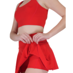 Close up of red tennis skirt with built in shorts women athletic sportswear detail