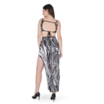 Woman wearing black and white abstract print bodycon maxi dress with spaghetti straps and side slit, stylish party wear outfit for women