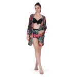Woman wearing black tropical print bikini set with matching sheer cover-up and shorts, stylish 3 piece beachwear outfit for women